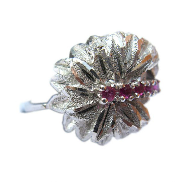 Ladies silver plated ring with five small created rubies set within a leafy backdrop