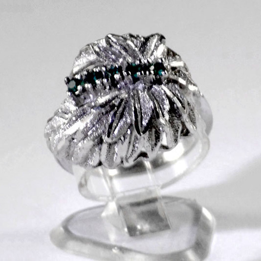 Ladies silver plated ring with five small created emeralds set within a leafy backdrop