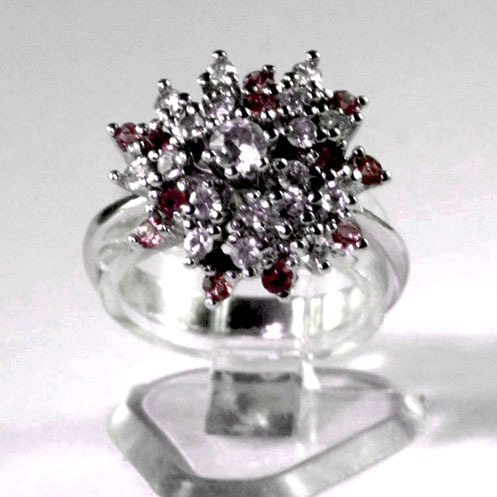 Silver plated ladies dress ring with a combined cluster of small bright crimson and white synthetic stones with a larger white centre stone