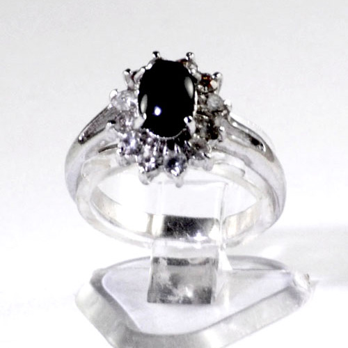 Ladies silver plated dress ring with oval black onyx centre stone surrounded by small sparkling cubic zyrconias