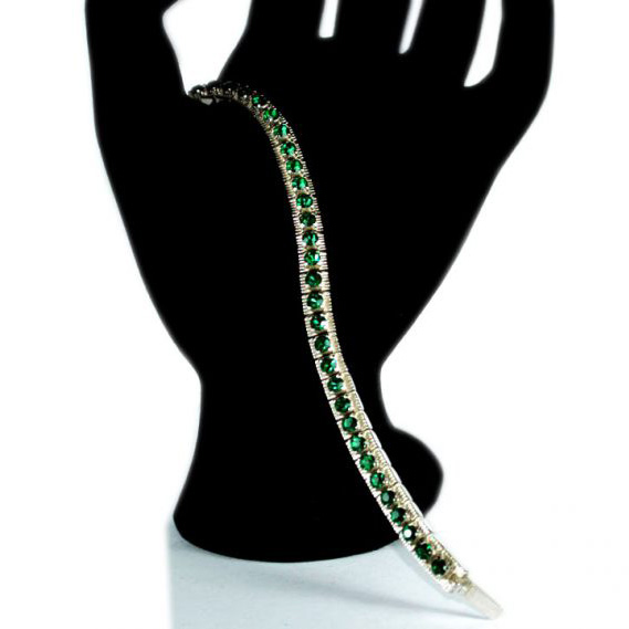 Top quality hard silver plated Italian made bracelet with a center row filled with deep green emerald simulants
